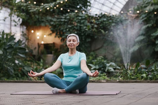Elderly woman meditates